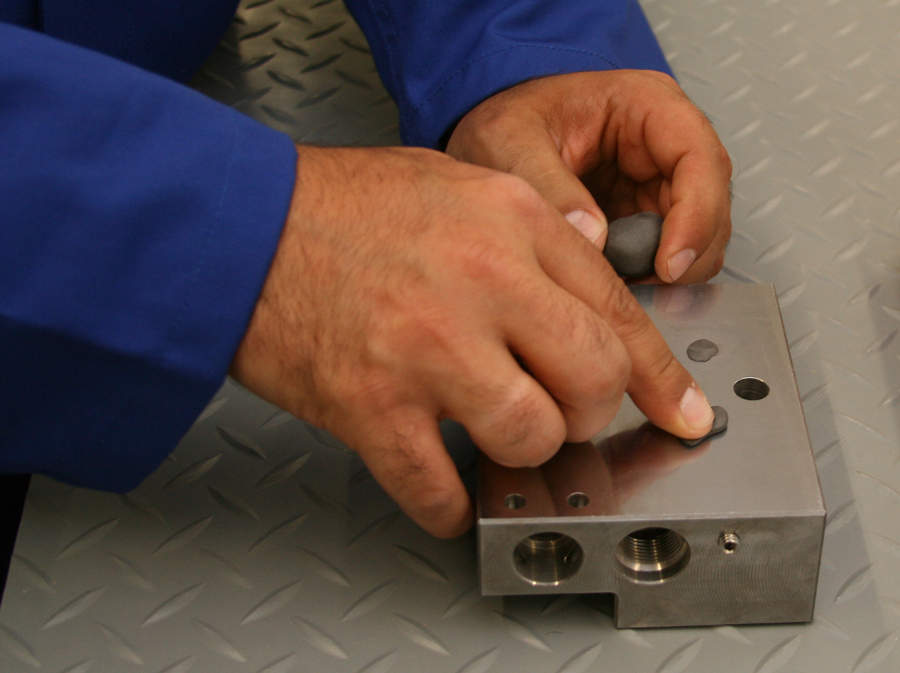 Repair Stick Steel being used to fill holes and recondition threads in a steel component